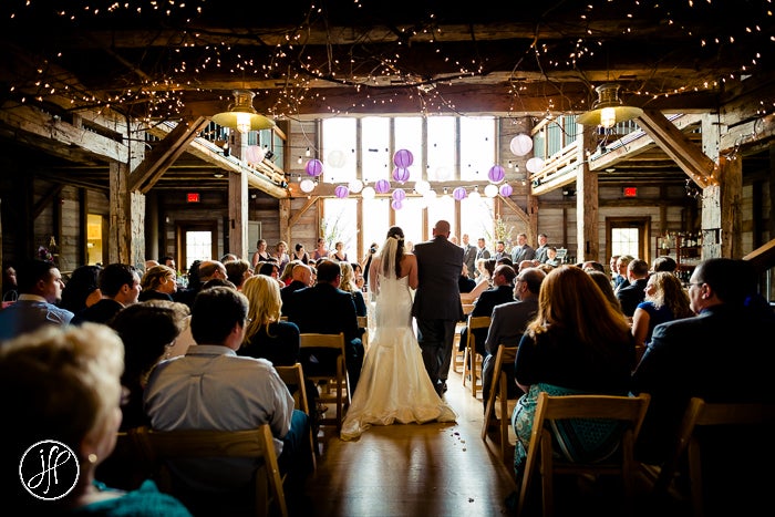 Bride and groom walking down the aisle inside of Pat's Barn�